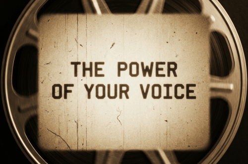 Text THE POWER OF YOUR VOICE over a spinning vintage film reel.